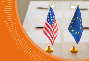United States and European Union flags standing side by side indoors