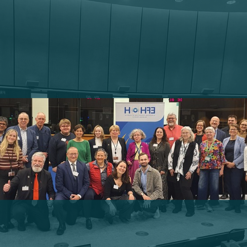 Group photo of speakers and participants at a European Parliament event for World Hearing Day 2026 on hearing health and inclusion.