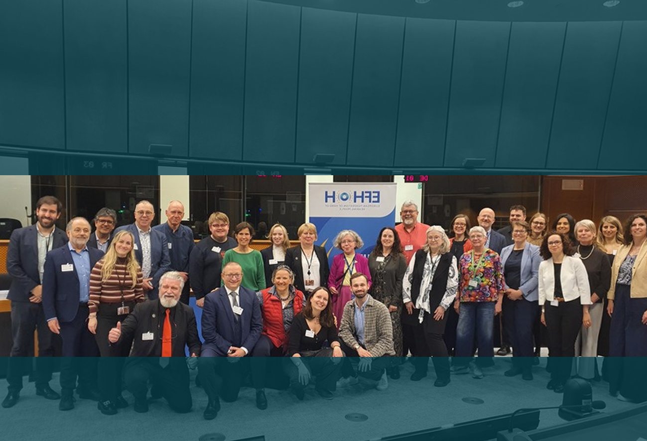 Group photo of speakers and participants at a European Parliament event for World Hearing Day 2026 on hearing health and inclusion.