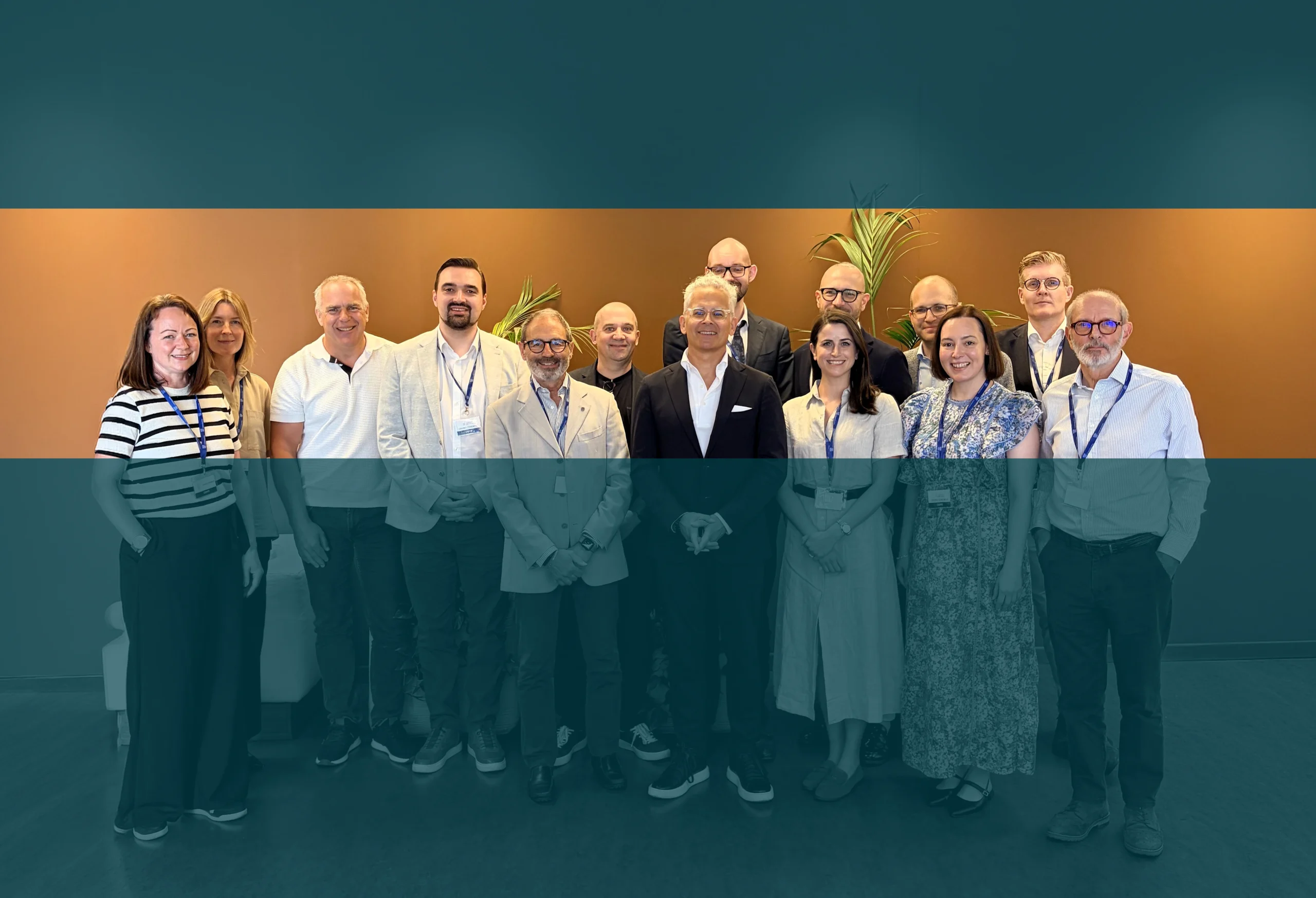 Group of people standing together at an industry event, with a teal overlay and event-style banner design.